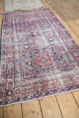 Angled view highlighting the vintage Anatolian runner's texture and geometric design in red and cobalt blue.