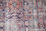 Detailed texture of the hand-knotted pile showing foundation and wear to the knot heads.