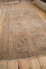 Distressed vintage Ersari rug pile featuring time-softened brown guls and ivory.