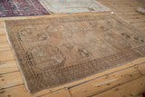 Ersari rug corner, showcasing its worn brown pile, subtle nuanced tones, and light fringe.