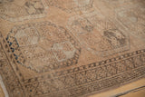 Distressed vintage Ersari rug detail, geometric guls with worn texture, brown, ivory, blue.