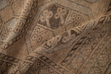 Nuanced coffee and chocolate brown distressed wool pile on the vintage Ersari rug.