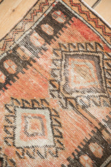 Visible knot heads and distressed texture on the Oushak rug's terracotta and brown corner.