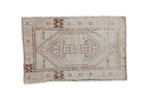 Vintage Distressed Oushak rug featuring a faded hexagonal medallion, geometric floral patterns, antique ivory, brown, and pastel tones, 2'9