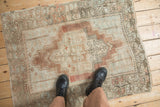 Distressed Anatolian rug, central medallion, faded blush, ivory, and powder blue.