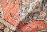 Textured, decorative distressed pile on a vintage Oushak rug, featuring brick red, charcoal, and beige.