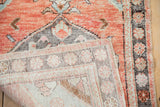 Distressed vintage Oushak rug showing brick red orange pile and woven beige foundation texture.