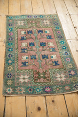 Distressed dusty blush Oushak with germinating tree of life and starburst floral border.
