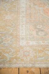 Evenly worn pile of a distressed Oushak rug, showing the hand-knotted texture and muted colors.