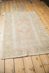 The overall softened pattern and muted colors of a distressed Oushak rug.