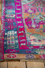 Hand-knotted vintage Kars rug border in magenta, dusty blue geometric motifs, showing even wear.