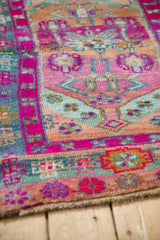 Vintage Kars rug with vibrant magenta and seafoam geometric patterns, visible abrash.