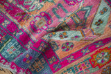 Vibrant magenta, seafoam, and gold geometric motifs displaying heavy abrashes and glittery fiber.