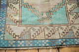 Stepped prayer motif and checkered border in pale turquoise, blue, and brown.