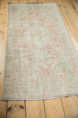 Hand knotted vintage Oushak runner with distressed texture, softened blush and seafoam green tones.