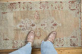 In-situ view of a distressed Oushak rug's soft, abrashed texture and soothing sand colored ground.