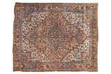 Vintage Persian Mehrivan carpet with stepped concentric medallions in dusty blush, sapphire blue, and brown.