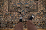 Distressed Mehrivan carpet featuring soft beige and blue hues with geometric serrated motifs.