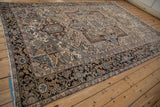 Dark chocolate and navy turtle samovar border of a distressed Mehrivan rug corner.