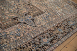 Distressed Mehrivan carpet detail: turtle samovar border, beige, dusty rose, navy, brown motifs.