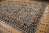 Dark turtle samovar main border with serrated buds and blossoms on distressed Mehrivan carpet.