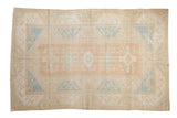 Vintage Distressed Dosemealti carpet with soft rose, ivory, and sky blue floral medallions.