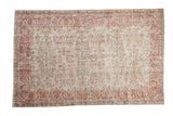Vintage distressed Sparta carpet with scrolling vines in dusty red and charcoal over a platinum field.