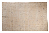 Vintage distressed Sparta carpet with an allover floral pattern in cream, beige, and dusty navy blue.