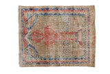 Distressed vintage Sparta square rug with a pictorial motif in faded cherry red, blue, and green.