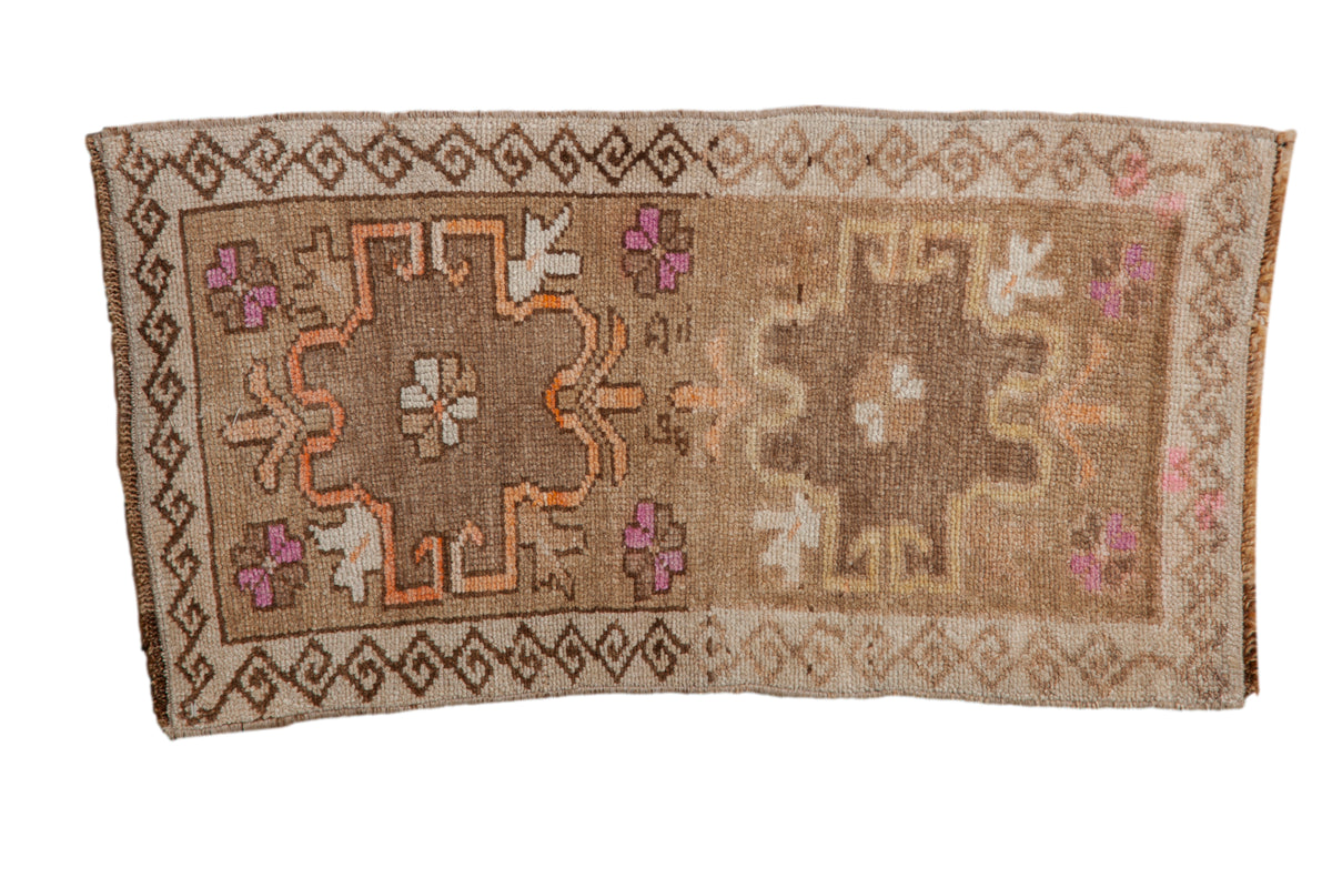 Distressed vintage Kars rug with a double medallion in brown, magenta, and faded orange tones.