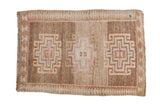Distressed Turkish Kars square rug with triple hook and latch medallions on an abrashed brown field.