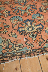 Hand-knotted vintage Lilihan rug's dusty blush floral field and border with wear.