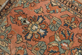 Detail of vintage Persian Lilihan rug displaying time-softened dusty blush and ocean green-blue floral motifs.