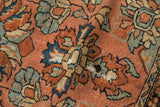 Vintage Lilihan rug's floral pattern with patina, showing threadbare areas and exposed foundation.