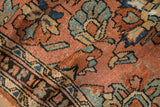 Folded vintage Lilihan rug showing delicate floral vinery and mostly even wear.