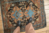 Overhead view showing the scale of a vintage Heriz rug's blue and terracotta double medallion.