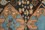Fine woven pile of a vintage Heriz rug with floral cross sections in sky blue, sandalwood, and dark brown.