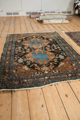 Perspective view of a fine Persian Heriz rug, detailing its double center medallion and intricate border system.