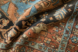 Close view of a fine Heriz rug's textured pile, showing floral motifs in sky blue and sandalwood.