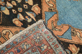 The reverse corner of a fine vintage Heriz rug showing the hand-knotted foundation.