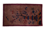 Vintage Art Deco rug with a pictorial landscape of a blossom tree, hut, and bird on a dusty mauve field.