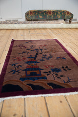 Vintage Art Deco rug with a pictorial scene, viewed from a low angle along its length.