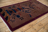 The complete pictorial scene of a vintage Art Deco rug framed by a solid burgundy border.