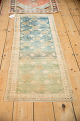 Distressed vintage Oushak runner with jade green, sand abrashes and intact side selvage.