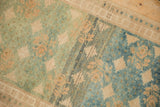 Textured pile of distressed Oushak rug, highlighting striking green to blue abrash and floral designs.