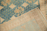 Hand-knotted beige foundation weave and secured side cord of a distressed blue Oushak runner.