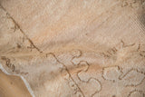 Close-up of the distressed rug's pile showing even wear to the knot heads.