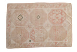 Vintage distressed Dosemealti rug with double column octagonal guls in blush, sand, and ivory.
