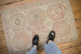 A perspective view showing the scale and worn, low-pile texture of a vintage Dosemealti rug.