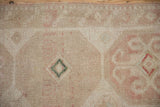 Even wear across the knot heads of a hand-knotted Turkish rug in blush and beige.